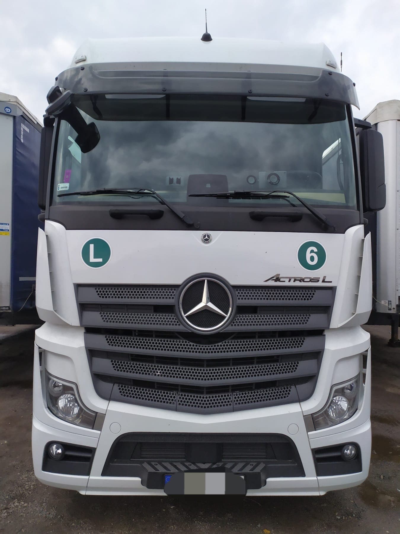 Front view of a white Mercedes-Benz Actros L unit number 6