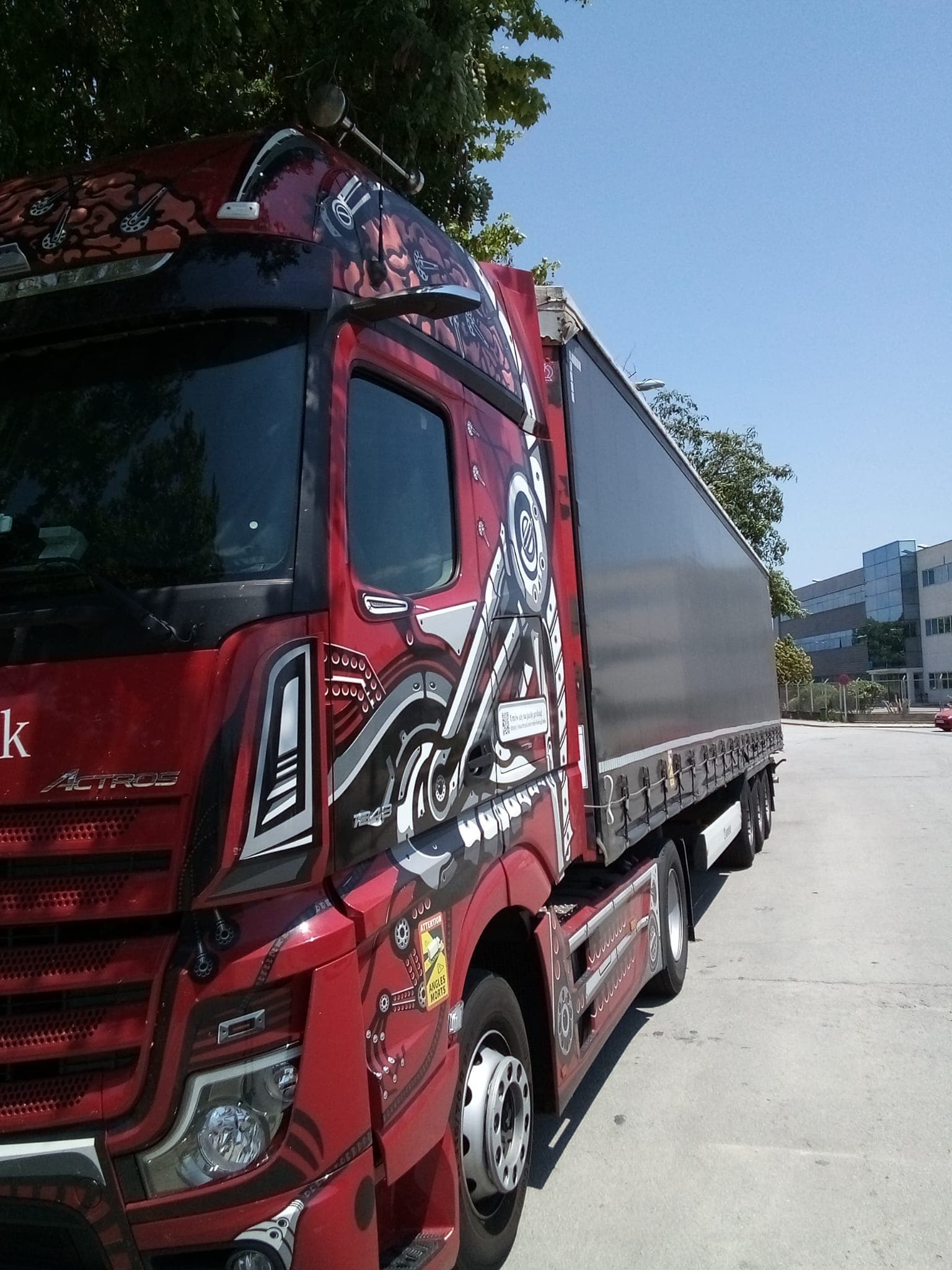 Red Actros SmartTruck coupled to a curtain-side trailer