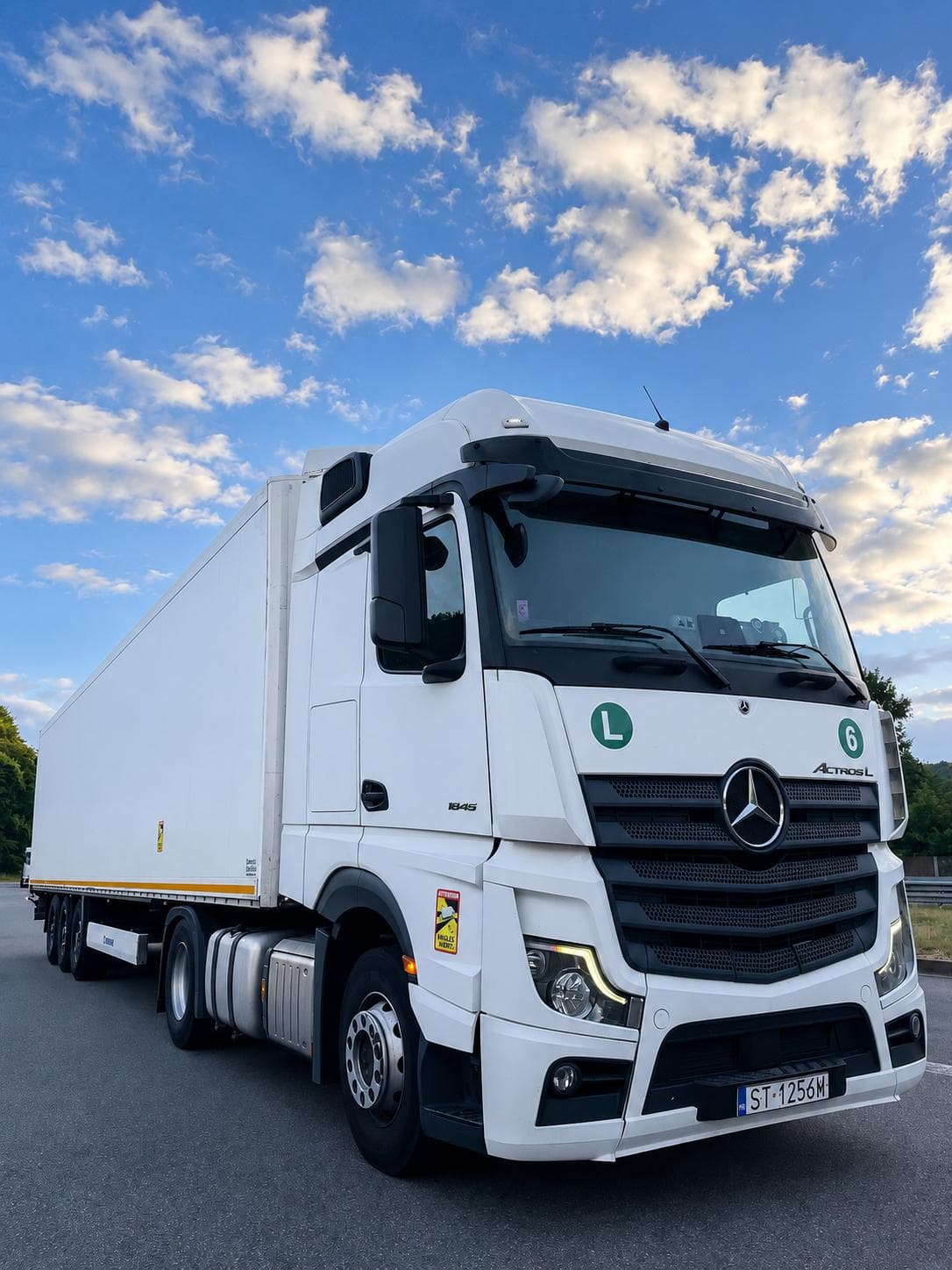 White Mercedes-Benz Actros L 1845 with a refrigerated trailer
