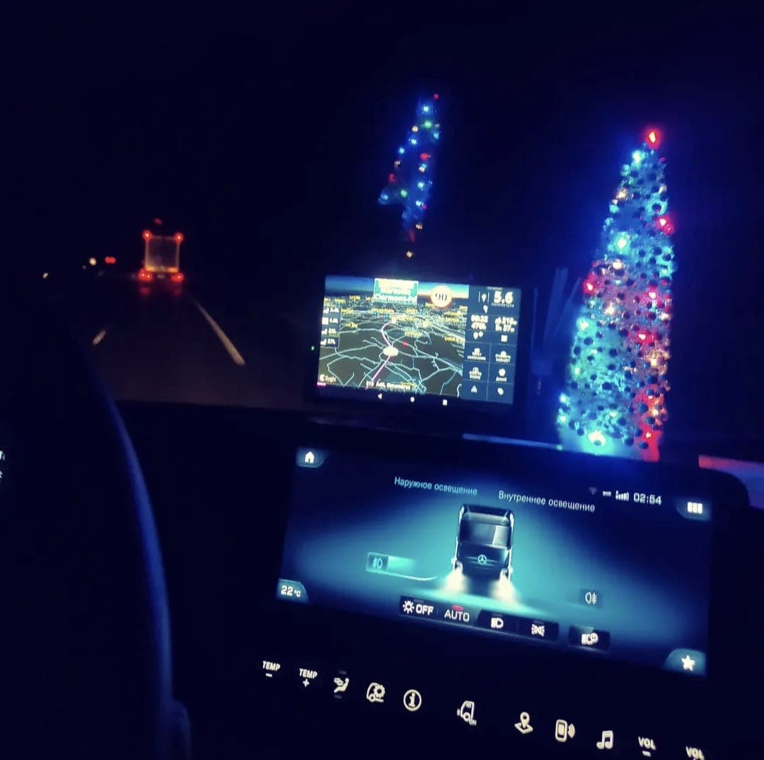 Night view from inside the cab showing navigation screens on a highway